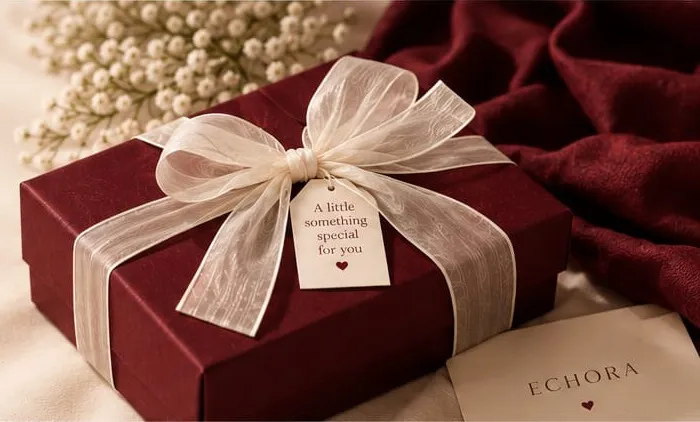 Burgundy ECHORA gift box tied with an ivory ribbon